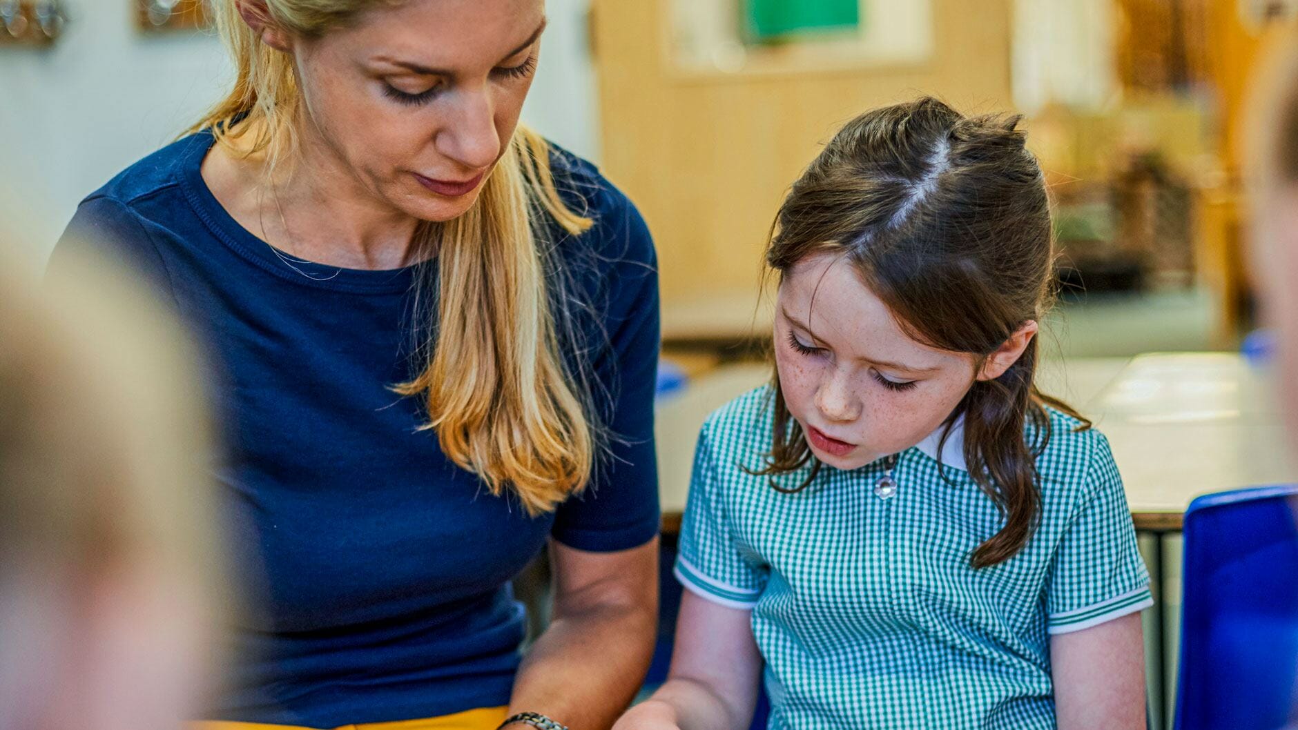 teacher helping child catch up